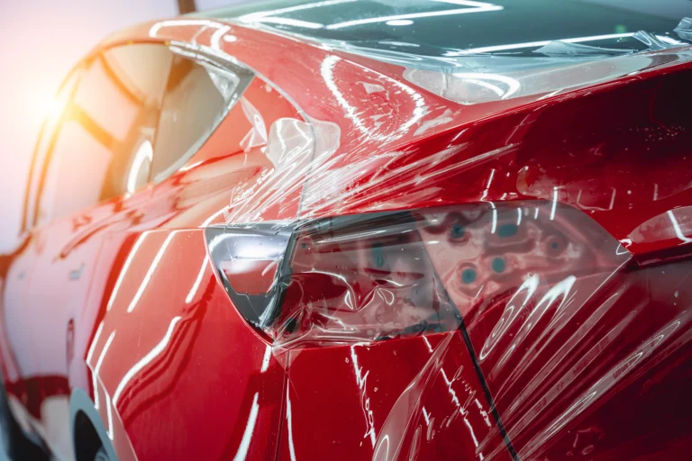 process-installing-protective-film-new-red-car